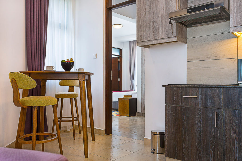 A furnished suite at L'Aziz Suites, laid out for stays measured in weeks rather than nights.
