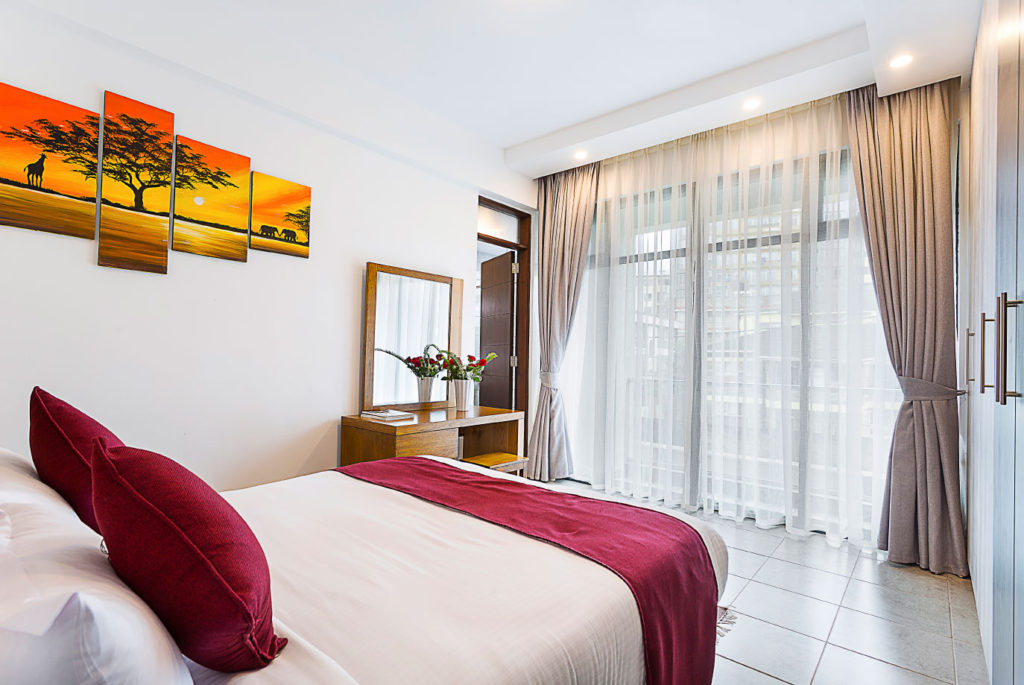 A furnished bedroom in a family suite at L'Aziz Suites, Nairobi.