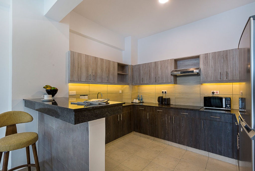 A full kitchen with worktop and cupboards, set up for preparing everyday family meals.