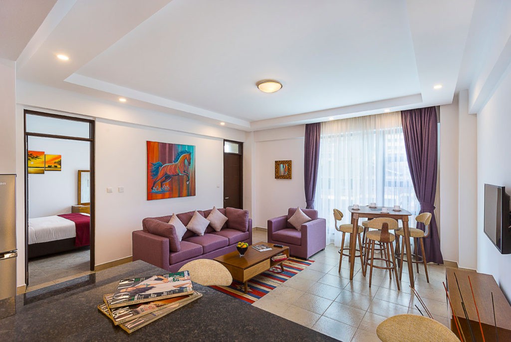 The living area of a family suite at L'Aziz Suites, with sofa seating and room to spread out.